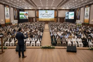A packed conference hall with hundreds of farmers attending a large educational seminar led by Crops Shop, featuring presentations on wheat production, and Global Sesame Demand in Pakistani Market